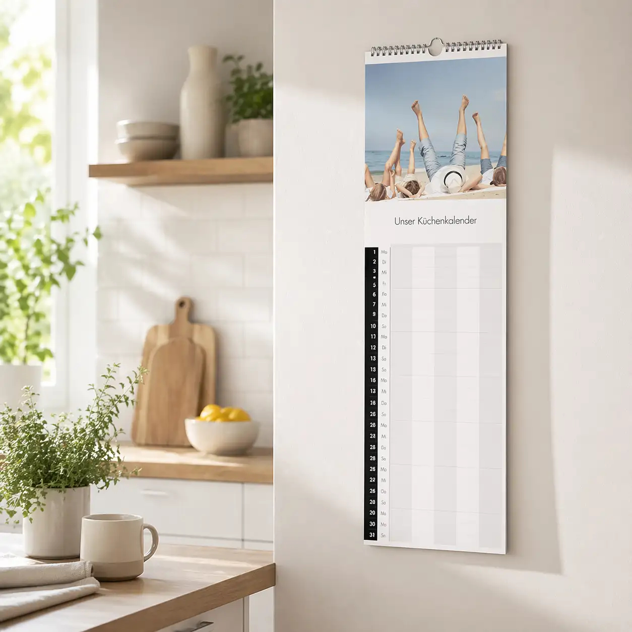 Küchenkalender mit Fotos an der Wand in einer hellen Küche